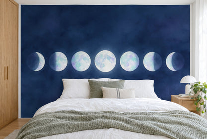 XXL printed fabric: seven moon discs in opal tones on night blue, full moon in the center, filling the wall behind the bed