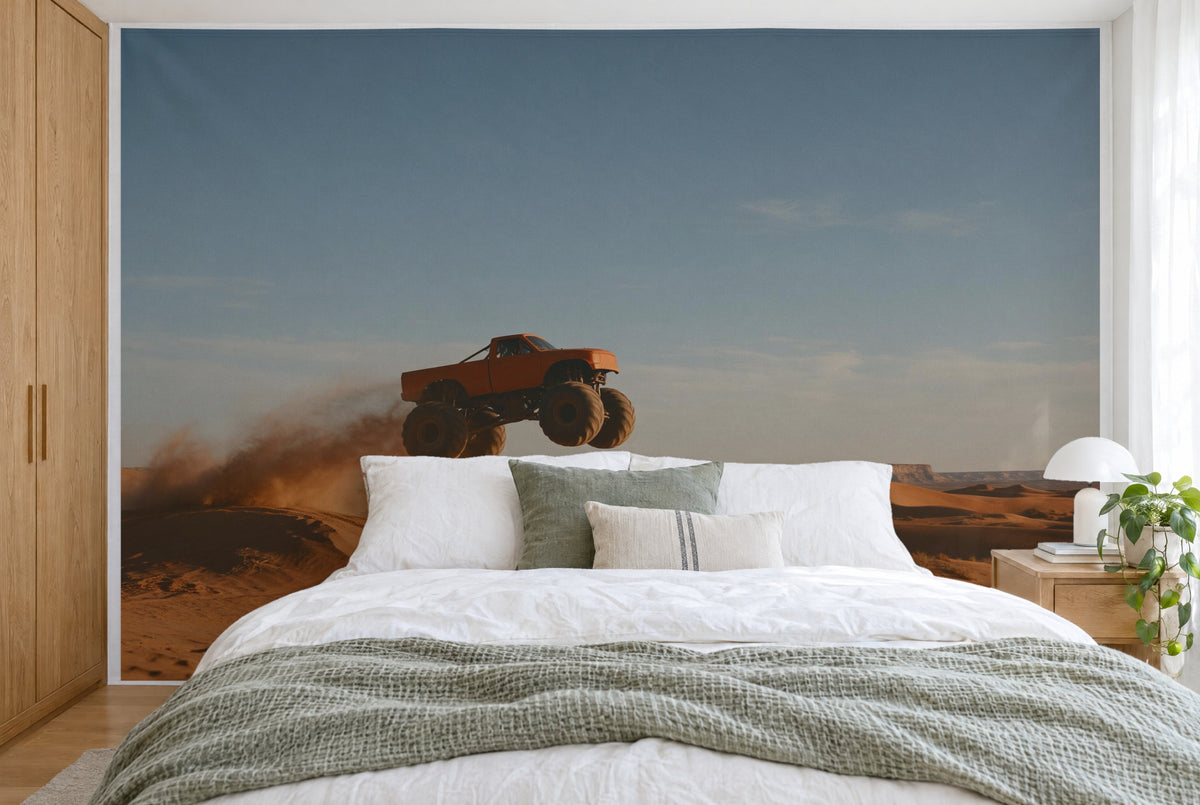 XXL printed fabric: monster truck mid-jump left of center, dunes and dust below, filling the wall behind the bed