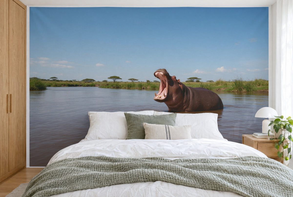 XXL printed fabric: hippo at right in the river with reeds and acacias, filling the wall behind the bed