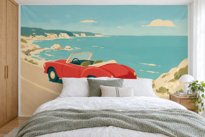 Bedruckter Stoff im XXL-Format: rotes Cabrio links der Mitte vor türkisblauem Meer und Felsen, wandfüllend hinter dem Bett