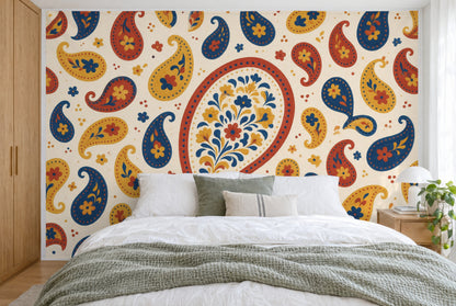 XXL printed fabric: red paisley medallion in the centre, yellow and blue paisleys all around, filling the wall behind the bed