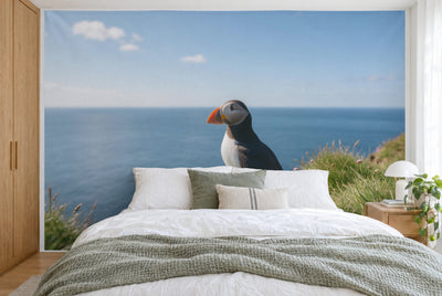 XXL printed fabric: puffin right of centre on cliff grass above the sea, filling the wall behind the bed