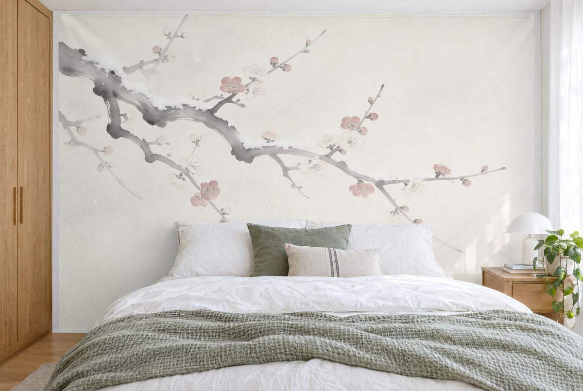 XXL printed fabric: gnarled plum branch with white and pink blossoms at upper left, filling the wall behind the bed