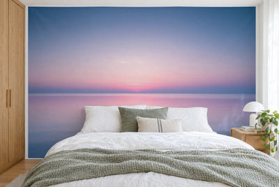 Tela impresa XXL: resplandor rosa en el horizonte en el centro, cielo azul arriba, cubre la pared tras la cama
