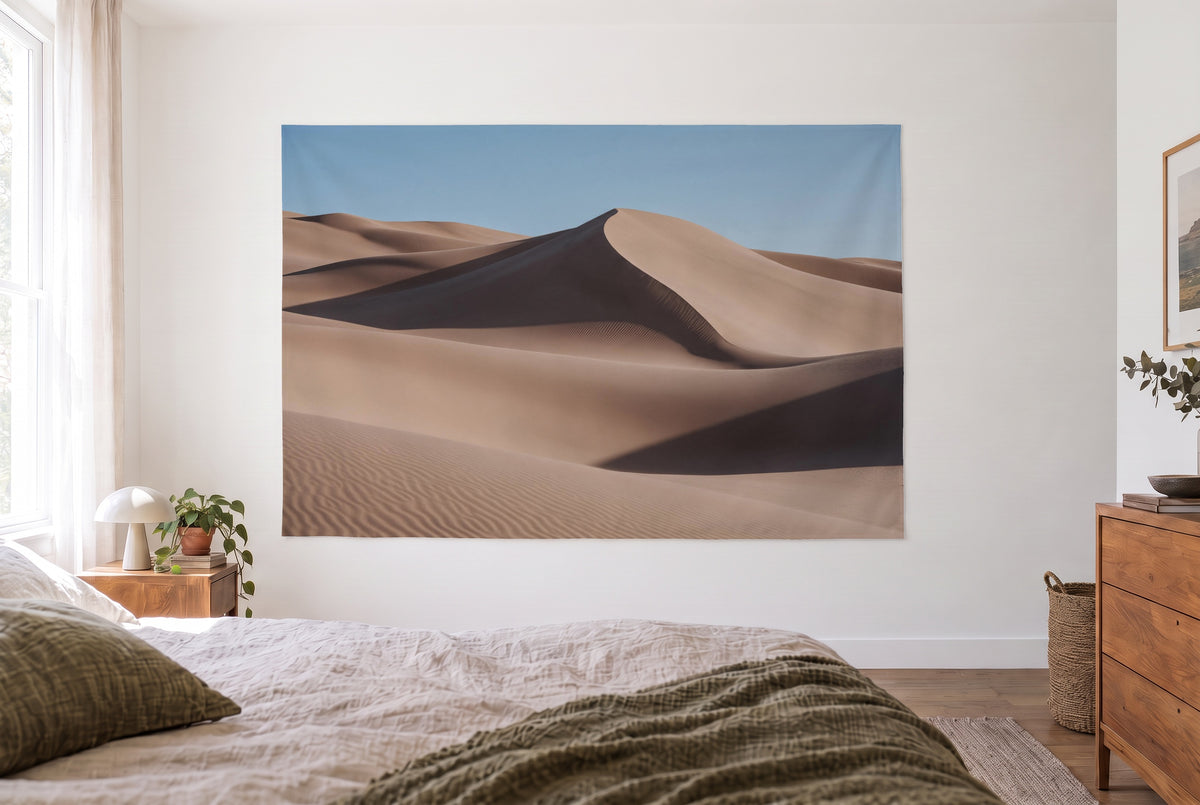 Wandtuch Sanddünen in der Wüste im hellen Schlafzimmer gegenüber dem Bett, rechts eine Holzkommode – Beige und Blau
