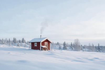 Red sauna cabin with a smoking chimney in a wide snowy landscape, tapestry printed on fabric – red and white