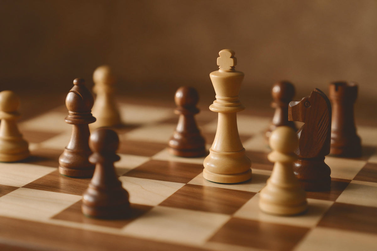 Light and dark wooden chess pieces in the middle of a game, king in focus, tapestry printed on fabric – brown and beige