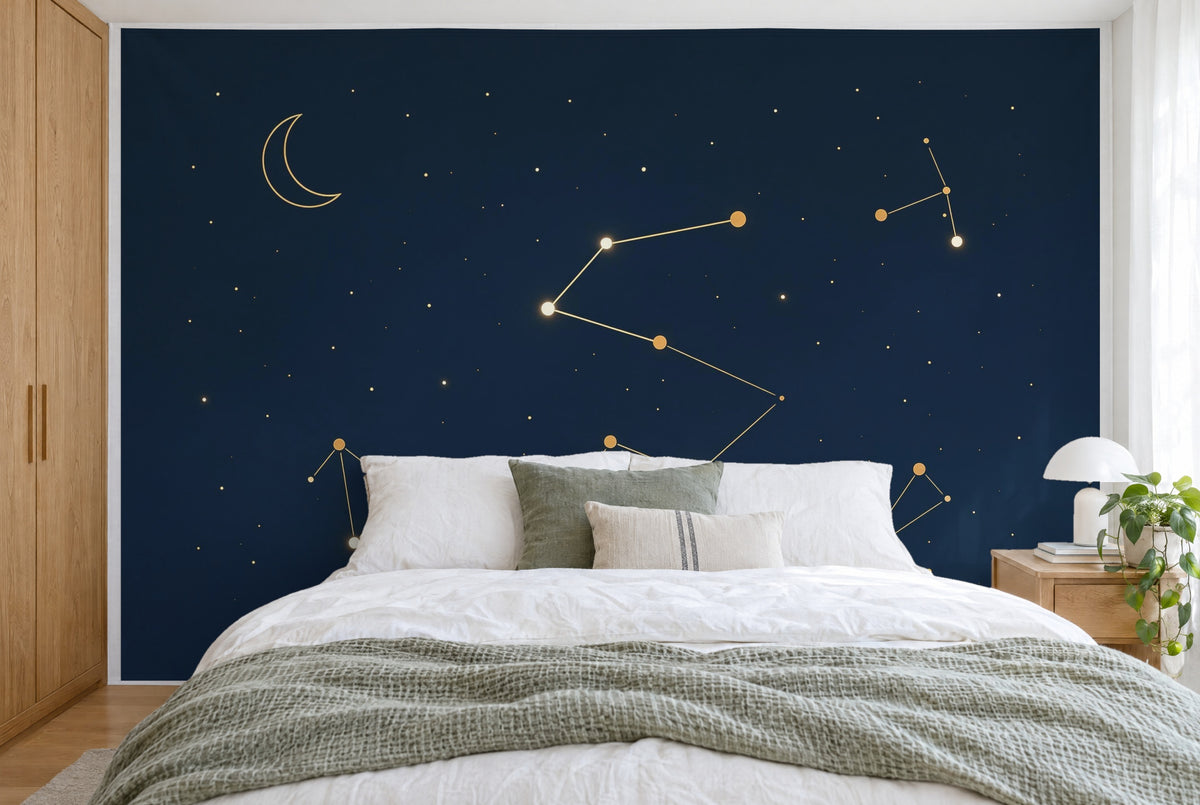 XXL printed fabric: golden constellation in the center, crescent moon top left on night blue, filling the wall behind the bed