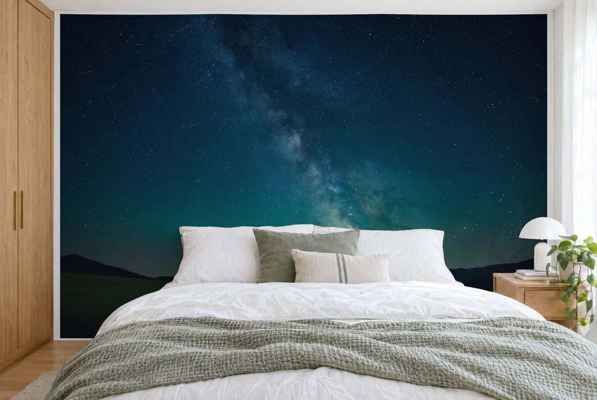 XXL printed fabric: Milky Way over ink-blue sky and mountains, filling the wall behind the bed