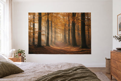 Forest Path in Autumn tapestry in a bright bedroom opposite the bed, wooden dresser at right – gold and brown
