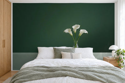 Tissu imprimé XXL : trois arums blancs dans un vase à droite du centre sur vert sombre, mur entier derrière le lit
