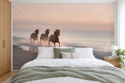 XXL printed fabric: three galloping wild horses at left in the spray, calm sea, filling the wall behind the bed