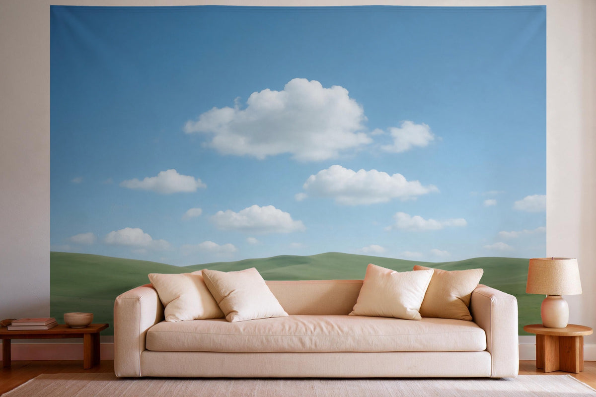 Tapiz de pared XXL Cielo azul con nubes sobre colinas verdes como decoración en un salón luminoso sobre el sofá