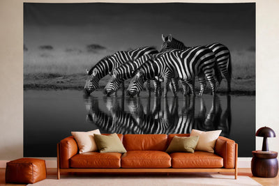 Wandtuch XXL Zebras in Schwarz-Weiss als Wanddeko im gemütlichen Wohnzimmer über dem Ledersofa