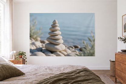 Zen stone cairn by the water tapestry in a bright bedroom opposite the bed, wooden dresser at right – beige and blue