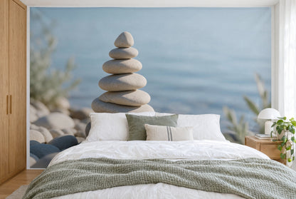 XXL printed fabric: pebble cairn left of centre in front of light blue water, full wall behind the bed
